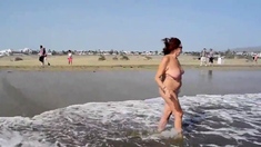 Adult woman shows her charms in the dunes